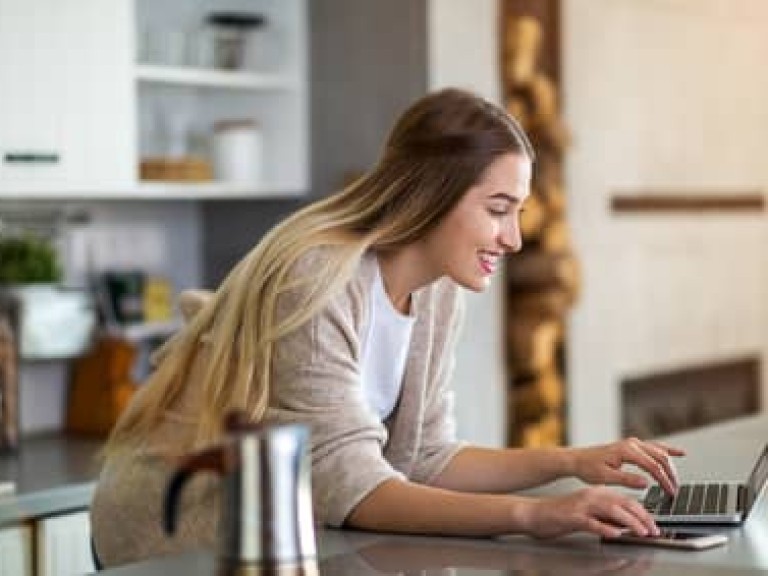 Young woman using her laptop at home