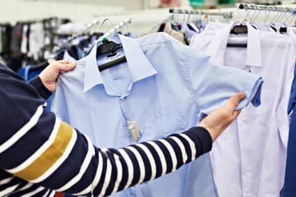 Man chooses shirt in shop