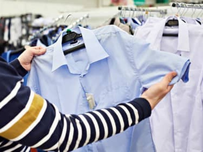 Man chooses shirt in shop