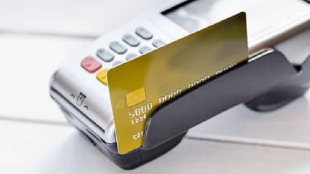 payment terminal with card on table background