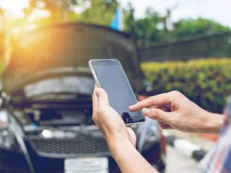 Man Phoning For Help with a broken down car