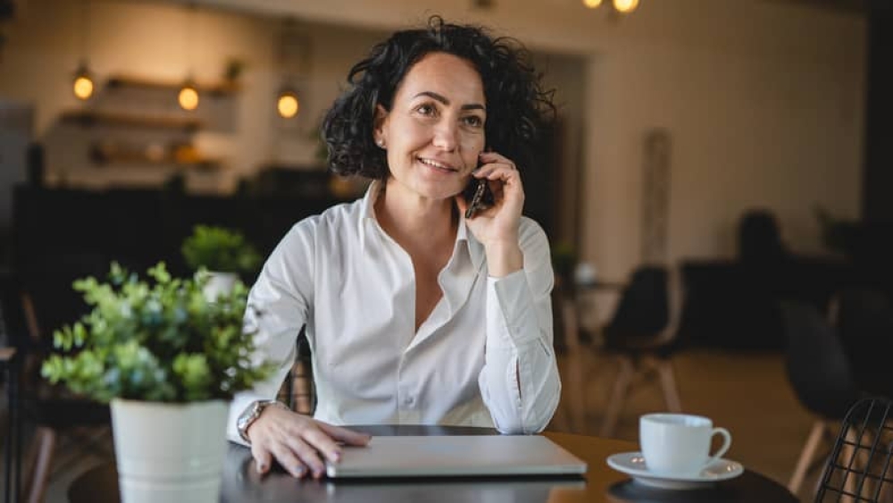 One woman use smartphone mobile phone while sit at cafe or restaurant