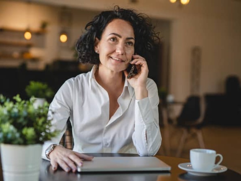 One woman use smartphone mobile phone while sit at cafe or restaurant