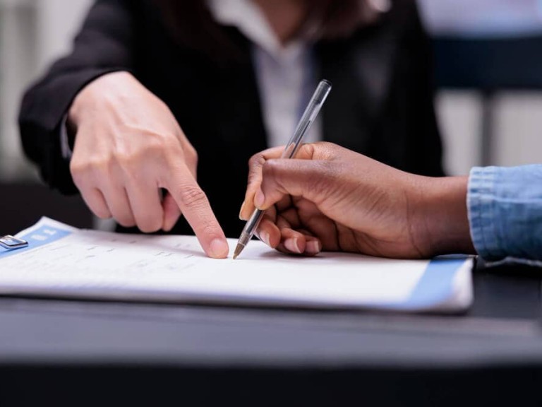 patient-filling-report-papers-reception-desk-signing-registration-forms-before-attending-checkup-visit-appointment-woman-writing-checkup-files-with-receptionist-healthcare-support-close-up (1)