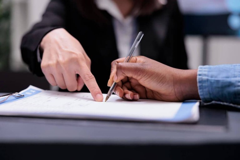 patient-filling-report-papers-reception-desk-signing-registration-forms-before-attending-checkup-visit-appointment-woman-writing-checkup-files-with-receptionist-healthcare-support-close-up (1)