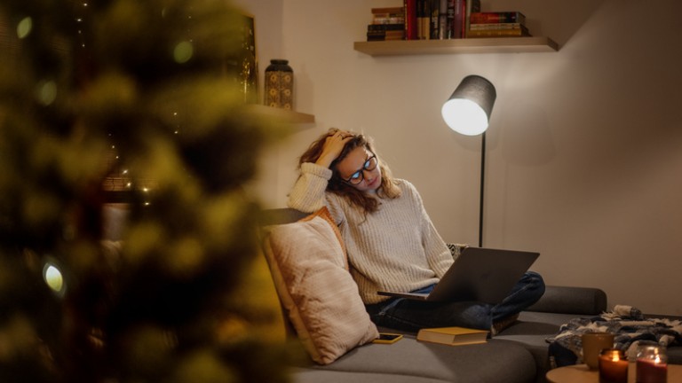 Frustrated tired  young woman in front of a laptop during the Christmas holidays.