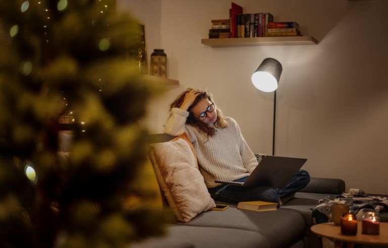 Frustrated tired  young woman in front of a laptop during the Christmas holidays.