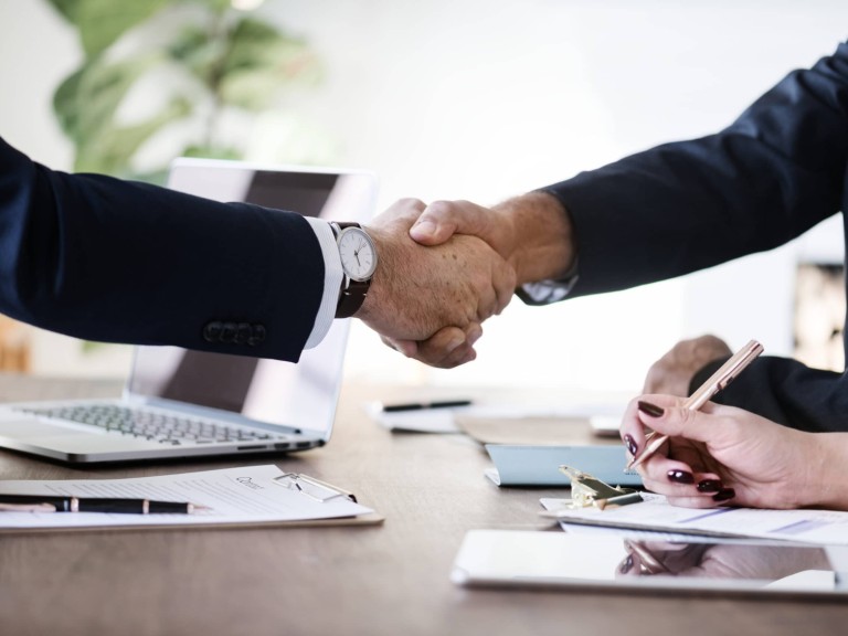 Business people shaking hands together