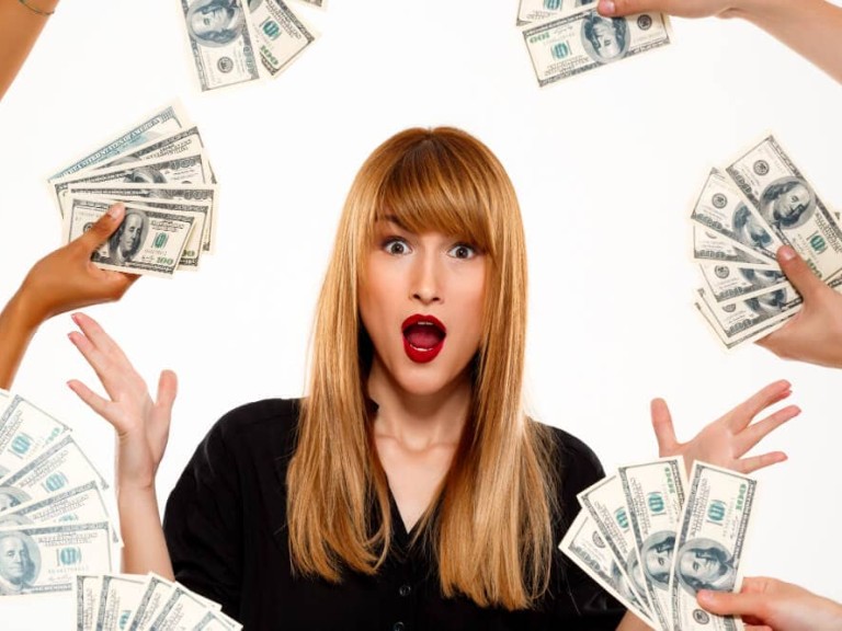 surprised-successful-businesswoman-among-money-white-wall (1)