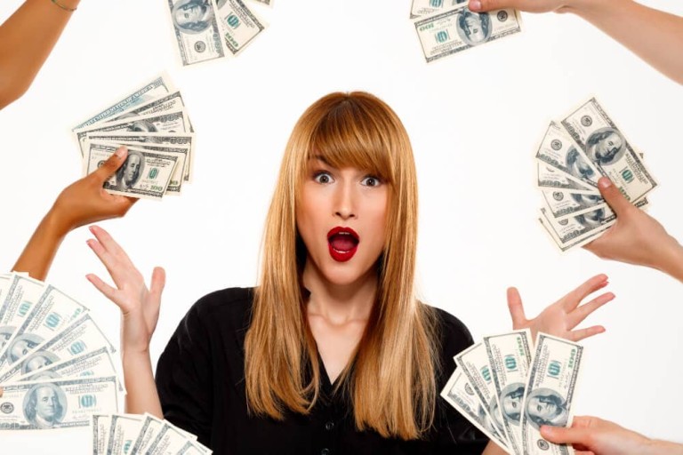 surprised-successful-businesswoman-among-money-white-wall (1)