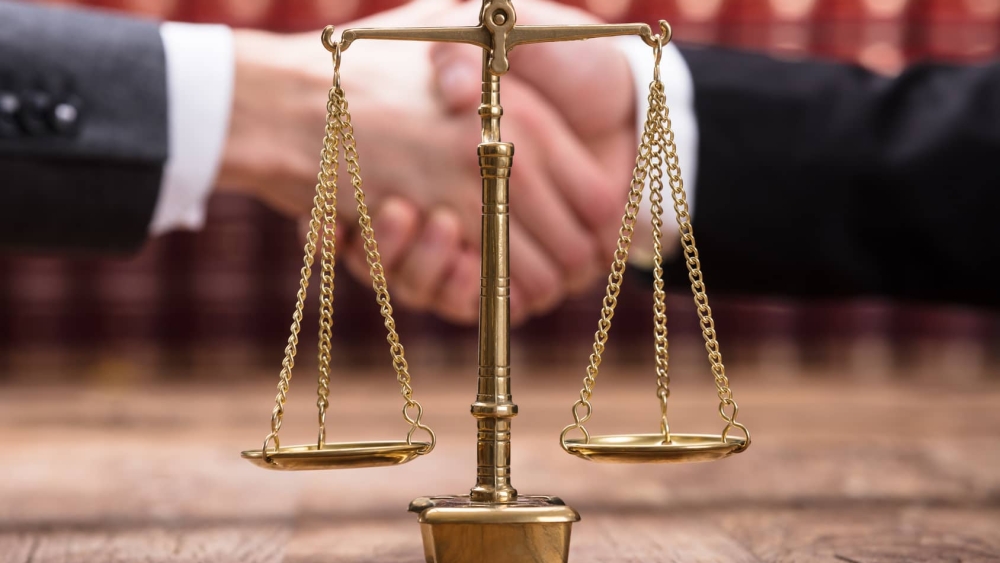 Close-up Of Justice Scale On Wooden Desk
