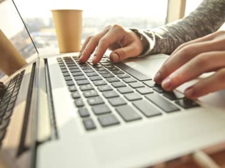 Young woman working at the modern laptop