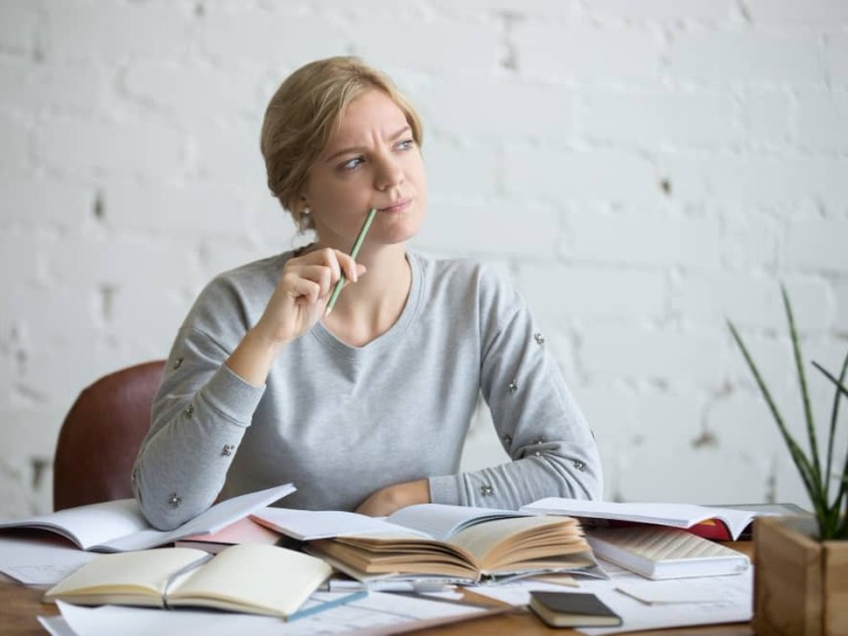 portrait-student-woman-desk-frowned