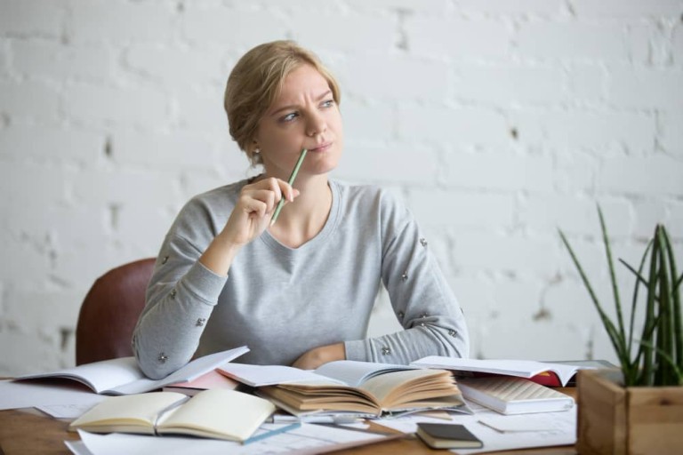 portrait-student-woman-desk-frowned