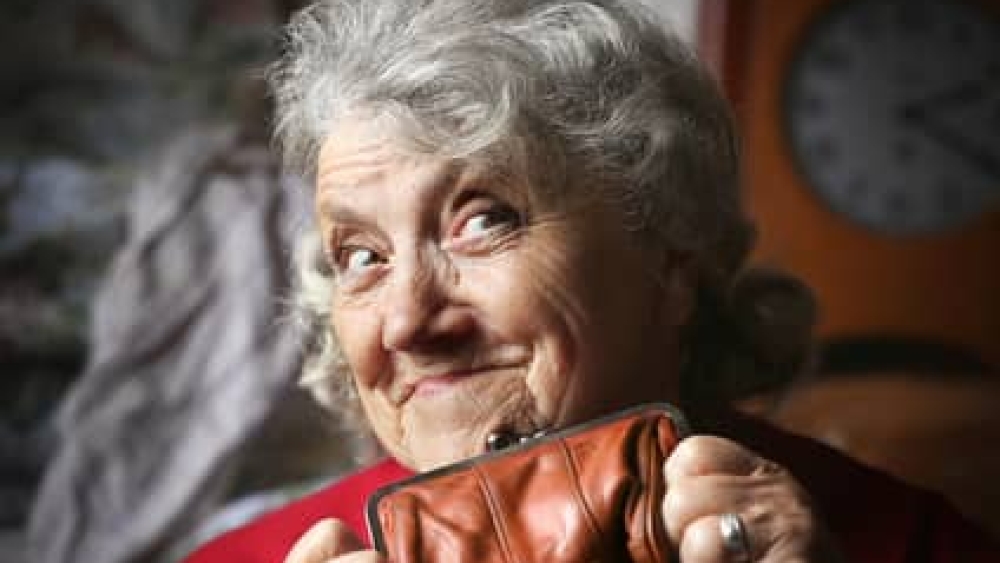 Smile and looking grandmother with purse