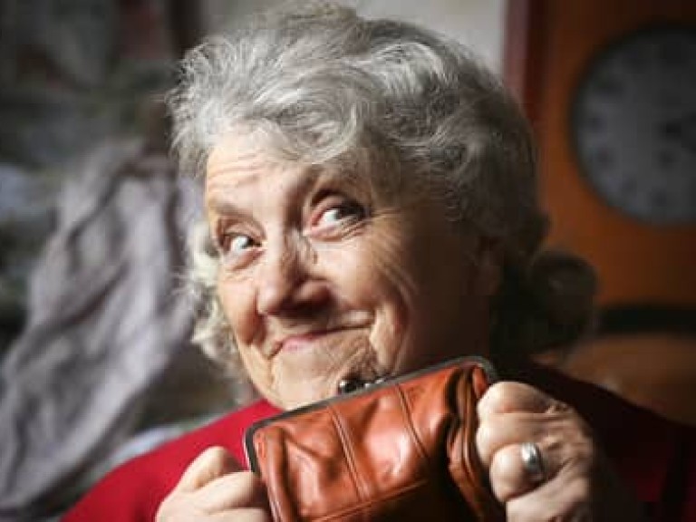 Smile and looking grandmother with purse