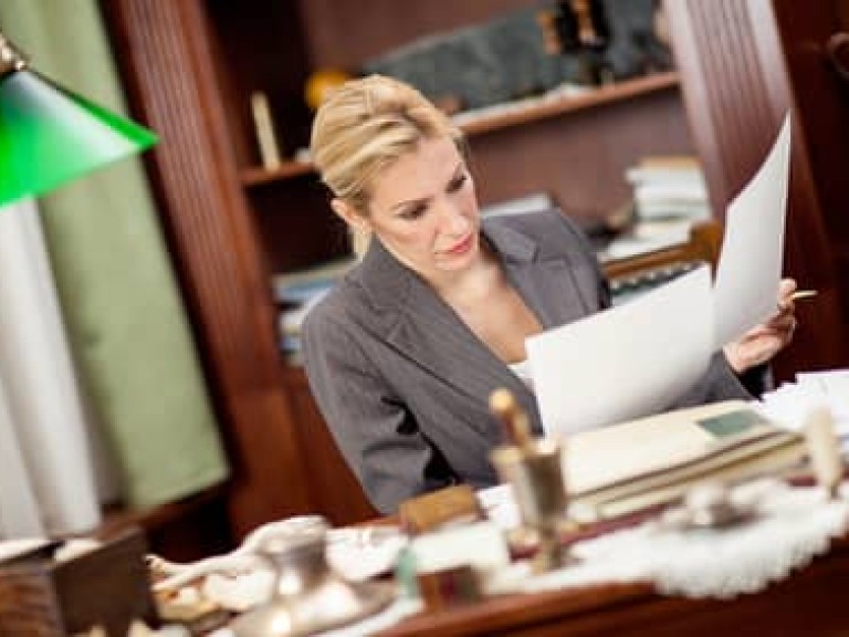 businesswoman sitting at a table in the office and working