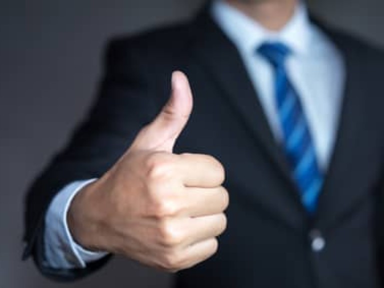 Businessman showing thumbs up - closeup shot