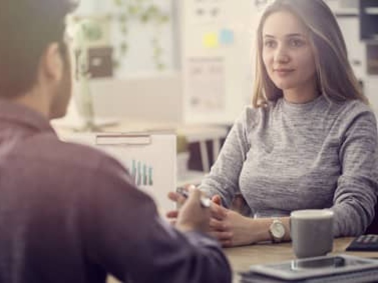 Young man talking a client in the office