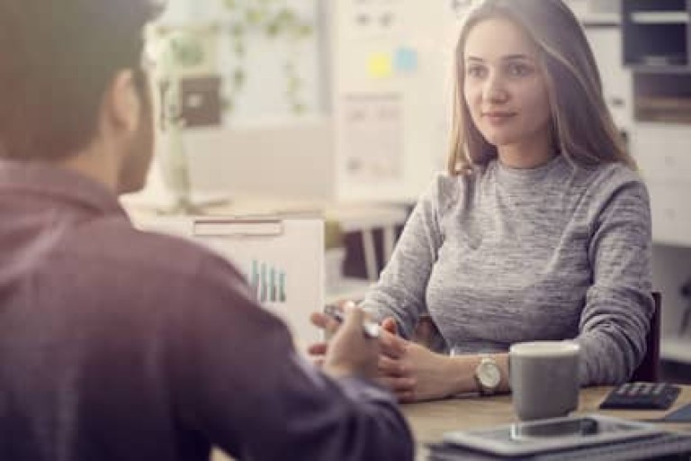 Young man talking a client in the office